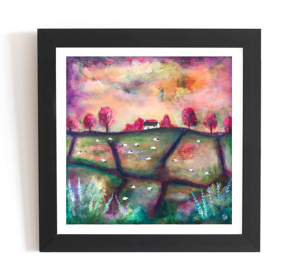 Framed artwork of a colorful landscape with trees and a house.